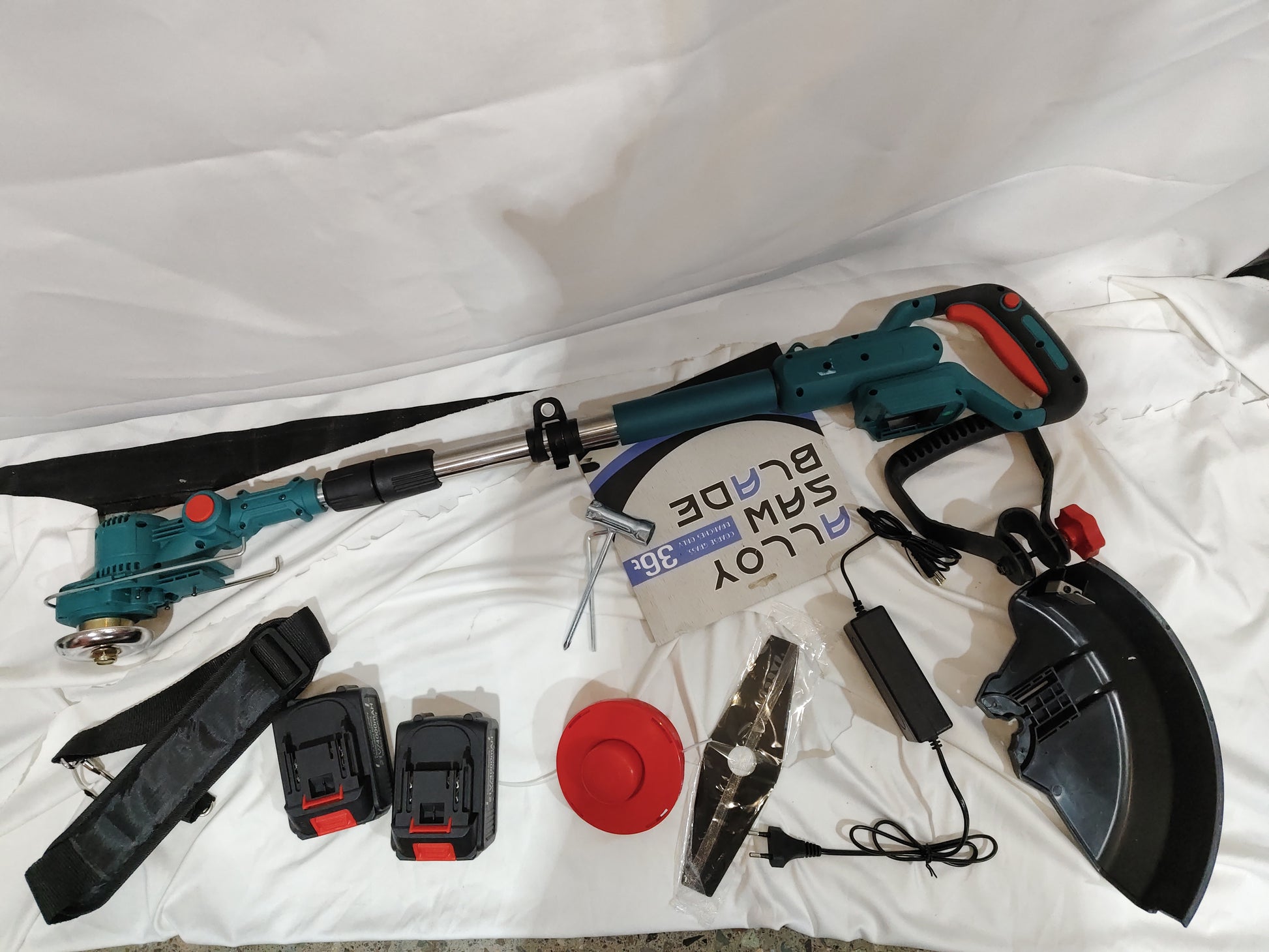 Folding Lithium Mower Electric Lawn Mower and accessories including batteries, blades, and protective gear.